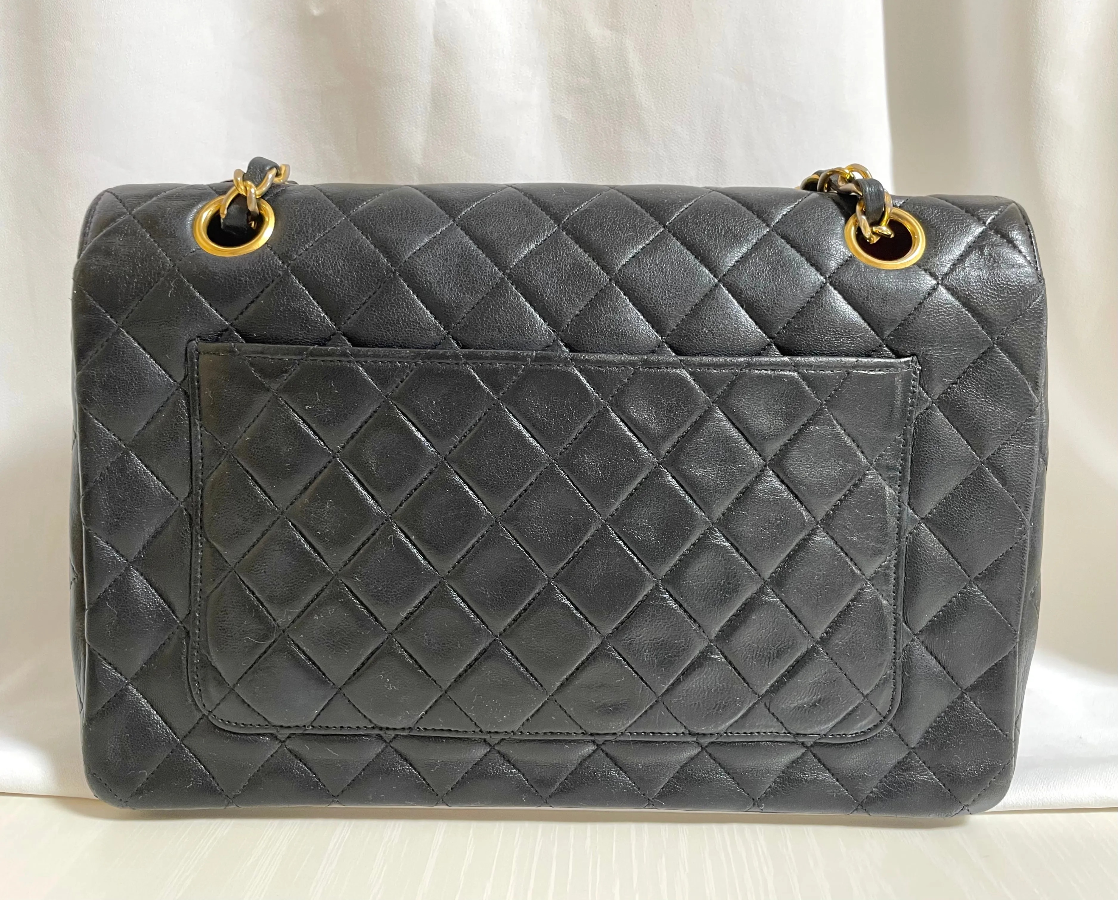 80's vintage Chanel black 2.55 shoulder bag with circle CC  flap design. Rare piece from the era. 0410283