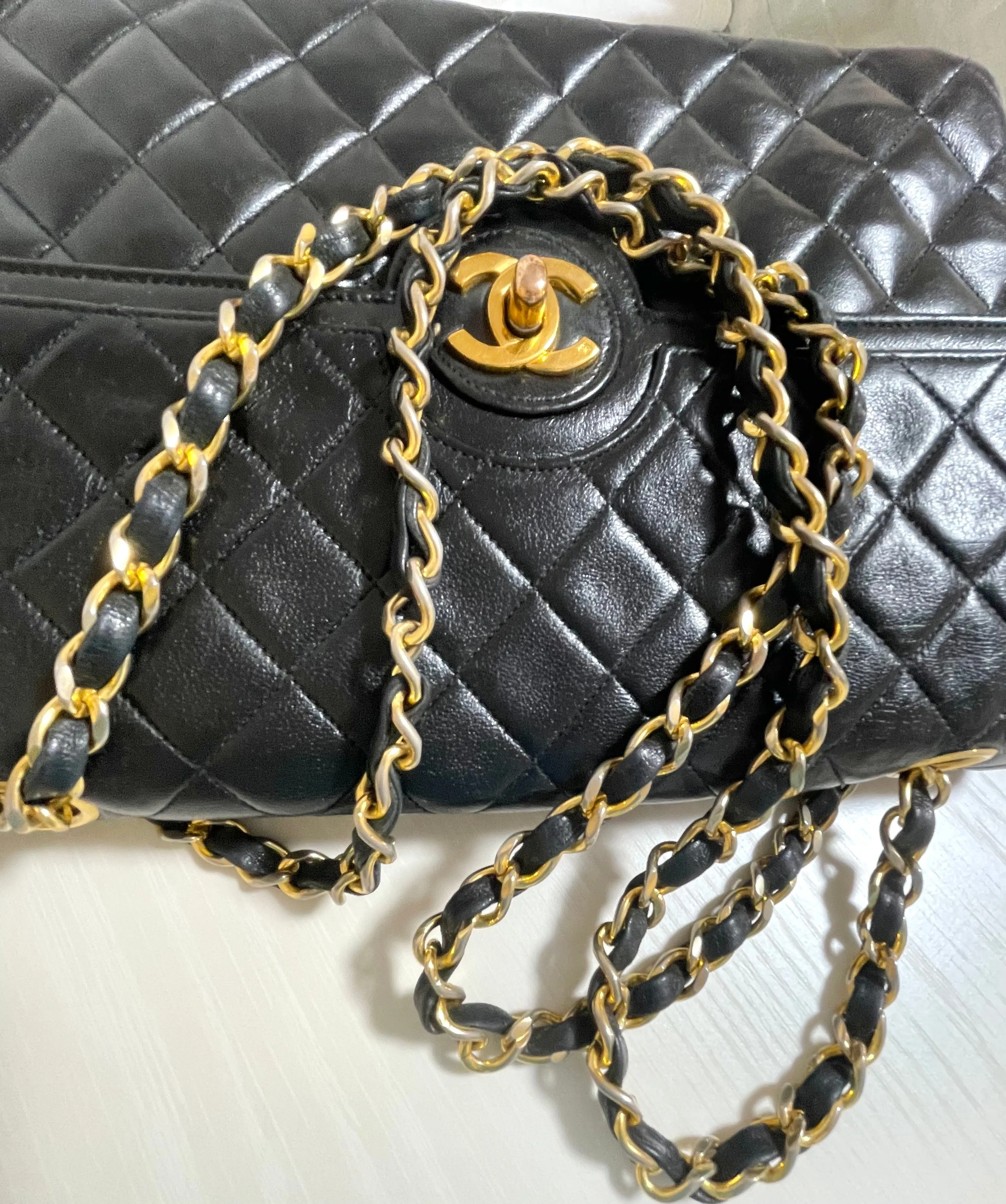 80's vintage Chanel black 2.55 shoulder bag with circle CC  flap design. Rare piece from the era. 0410283