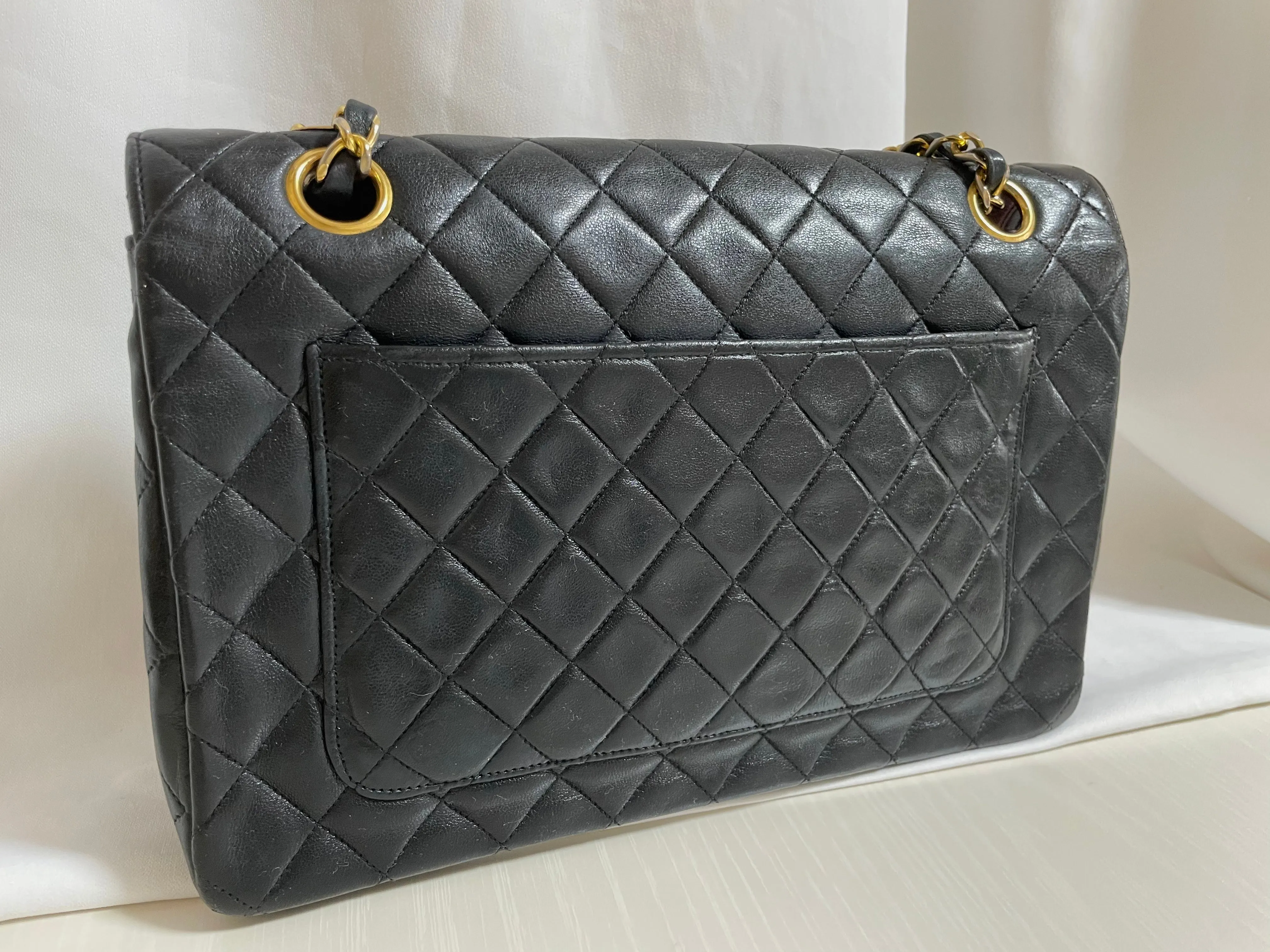80's vintage Chanel black 2.55 shoulder bag with circle CC  flap design. Rare piece from the era. 0410283
